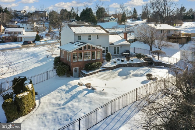 snowy aerial view with a residential view