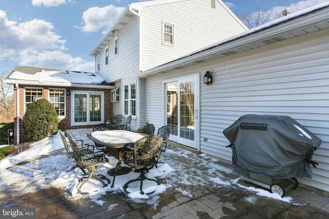 view of patio with area for grilling and outdoor dining area