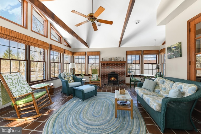 tiled living area featuring a ceiling fan, a healthy amount of sunlight, and high vaulted ceiling