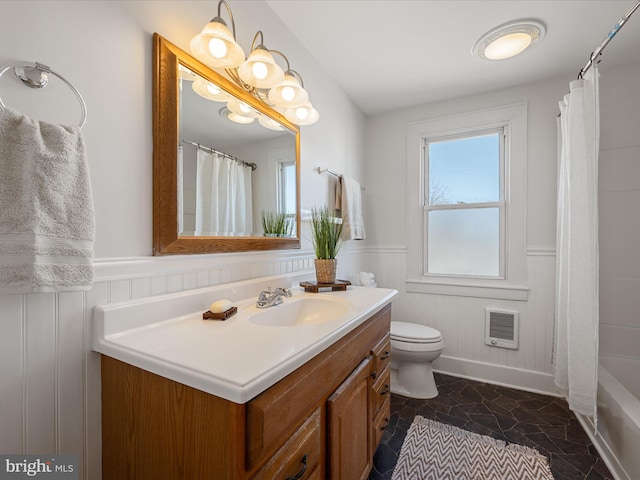 full bath featuring a wainscoted wall, toilet, a shower with shower curtain, and vanity