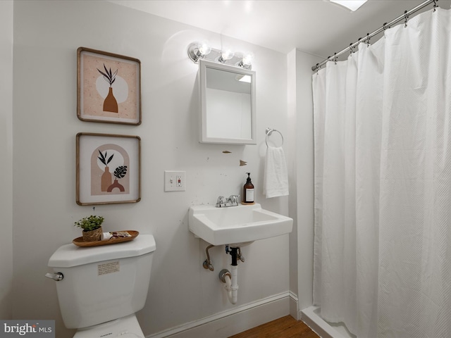 bathroom with toilet and curtained shower