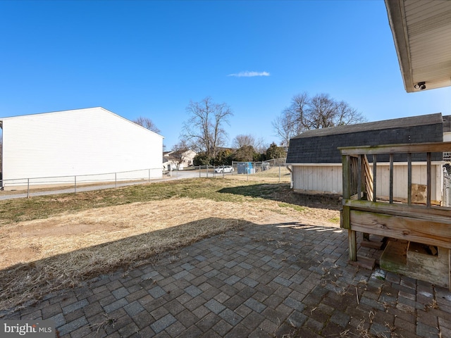 view of yard with a patio, a shed, an outdoor structure, and fence