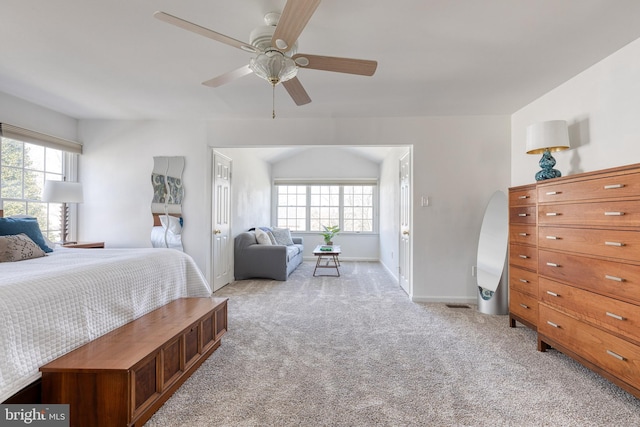 bedroom with ceiling fan, multiple windows, baseboards, and light colored carpet