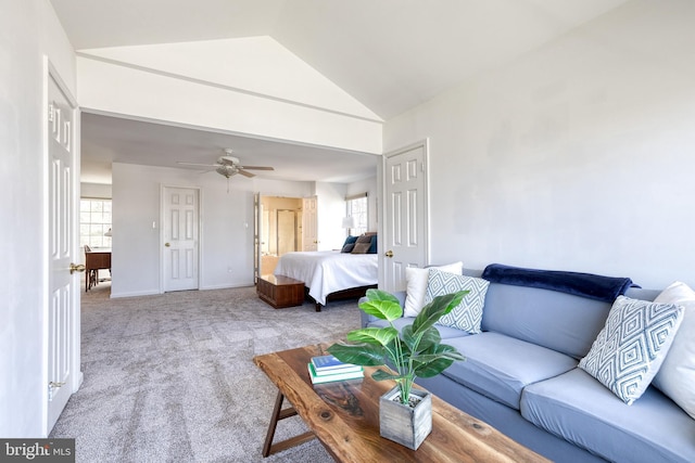 bedroom with a ceiling fan, carpet, lofted ceiling, and baseboards