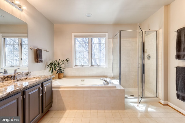 bathroom with vanity, plenty of natural light, a shower stall, and a bath