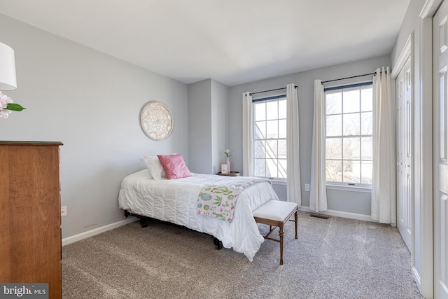 bedroom with carpet floors, visible vents, and baseboards