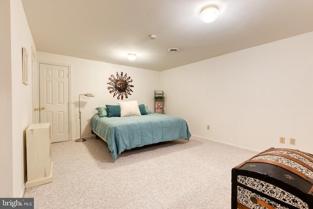 bedroom with visible vents, baseboards, and light colored carpet