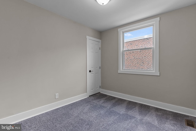 empty room featuring dark colored carpet