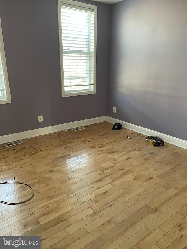 spare room featuring light hardwood / wood-style floors