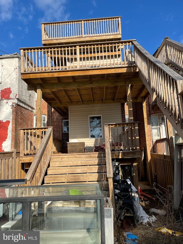 rear view of property featuring a deck