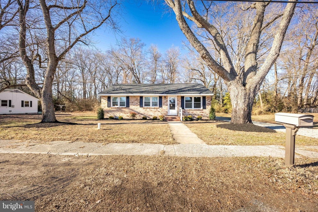 ranch-style house with a front lawn