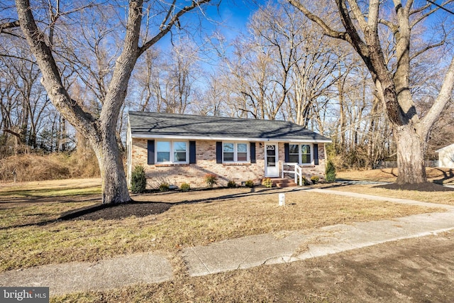 ranch-style home with a front lawn