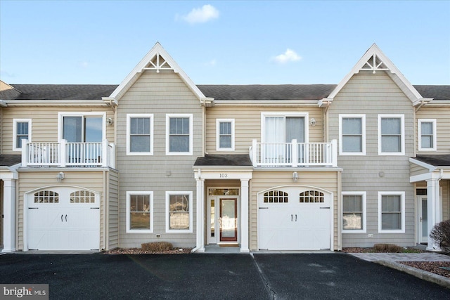 multi unit property with a garage and a balcony