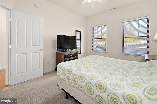 bedroom with lofted ceiling, light carpet, and ceiling fan