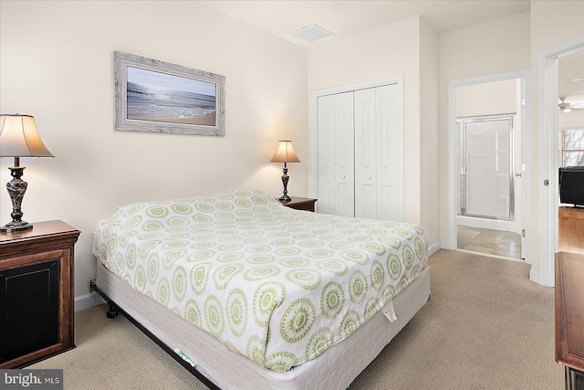 bedroom featuring light carpet and a closet