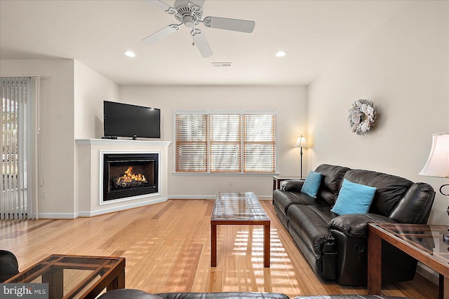 living room with ceiling fan and hardwood / wood-style floors