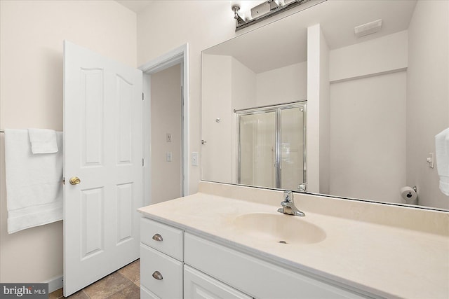 bathroom featuring vanity and a shower with door