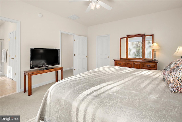 carpeted bedroom with ceiling fan and multiple windows