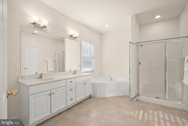 bathroom featuring vanity, tile patterned flooring, and separate shower and tub