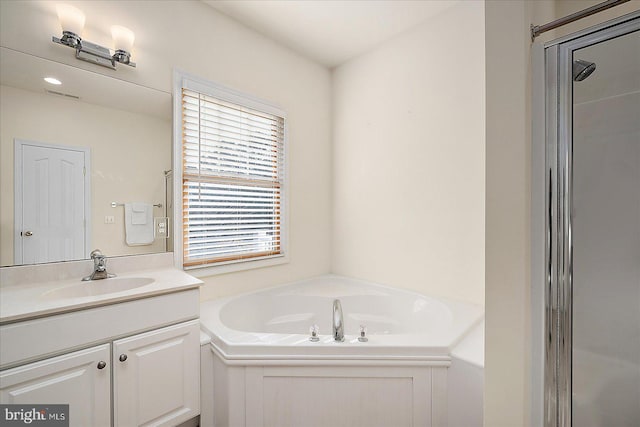 bathroom featuring vanity and plus walk in shower