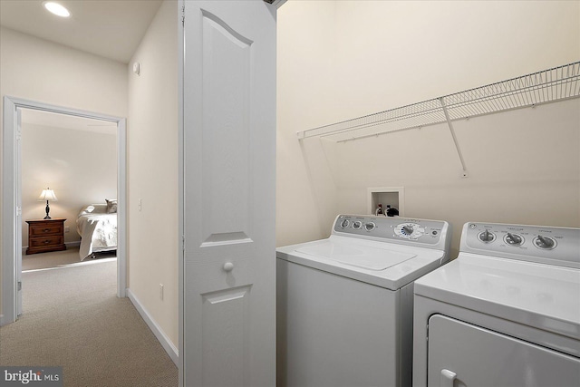 laundry area featuring washer and dryer and carpet flooring