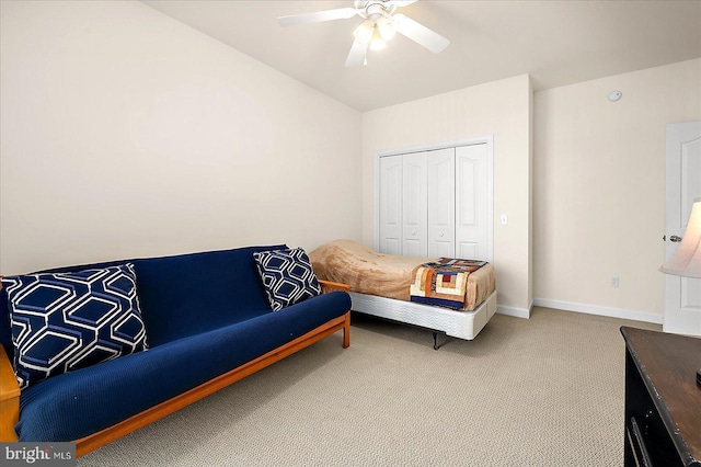 carpeted bedroom with ceiling fan and a closet