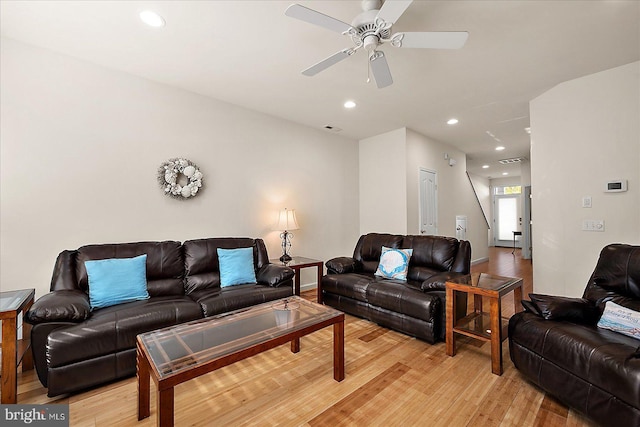 living room with light hardwood / wood-style floors and ceiling fan