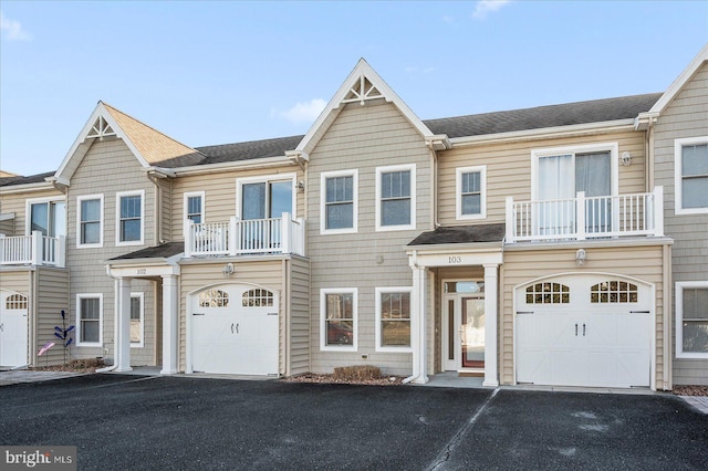 multi unit property with a garage and a balcony