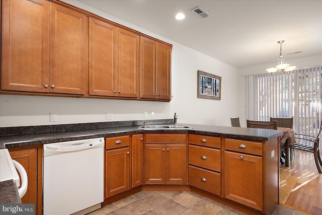 kitchen with sink, an inviting chandelier, decorative light fixtures, white dishwasher, and kitchen peninsula