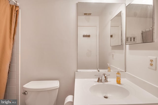 bathroom featuring sink, toilet, and a shower with shower curtain