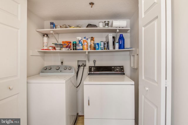 laundry area featuring separate washer and dryer and a textured ceiling