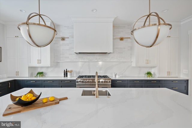 kitchen with white cabinetry, light stone countertops, and pendant lighting