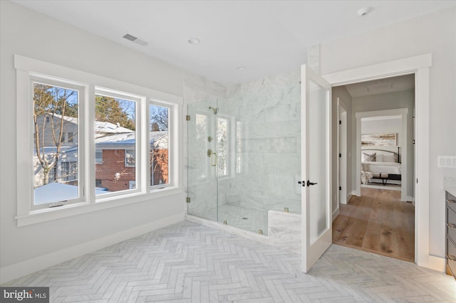 bathroom with vanity, a wealth of natural light, and walk in shower