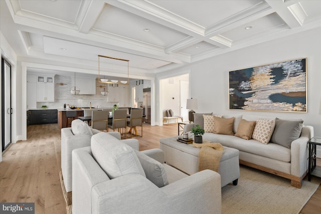 living room with coffered ceiling, beam ceiling, and light wood-type flooring