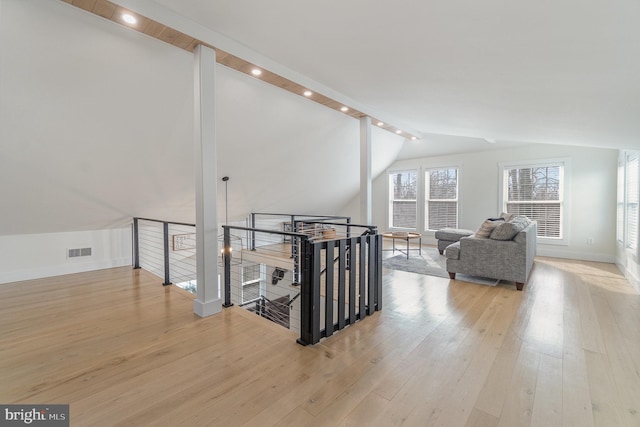 interior space featuring vaulted ceiling and light hardwood / wood-style flooring