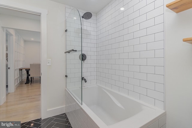 bathroom featuring tile patterned flooring and tiled shower / bath