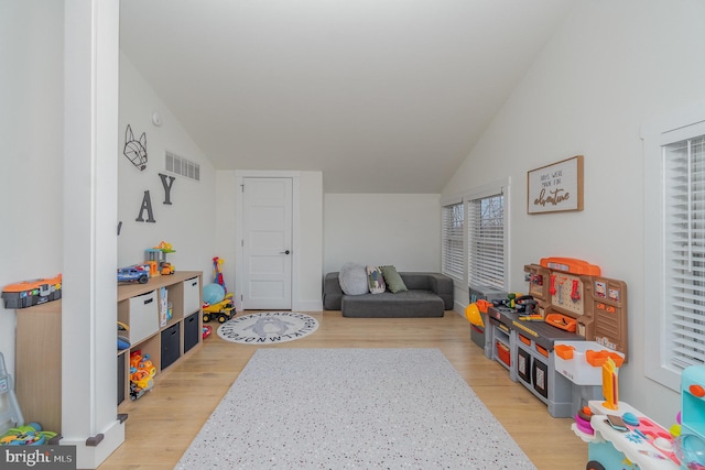 game room featuring light hardwood / wood-style flooring and vaulted ceiling