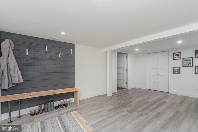 mudroom with light hardwood / wood-style flooring