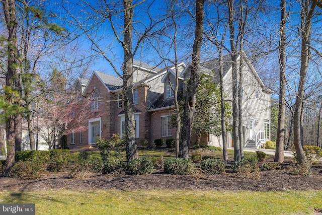 view of front of home with a garage and brick siding