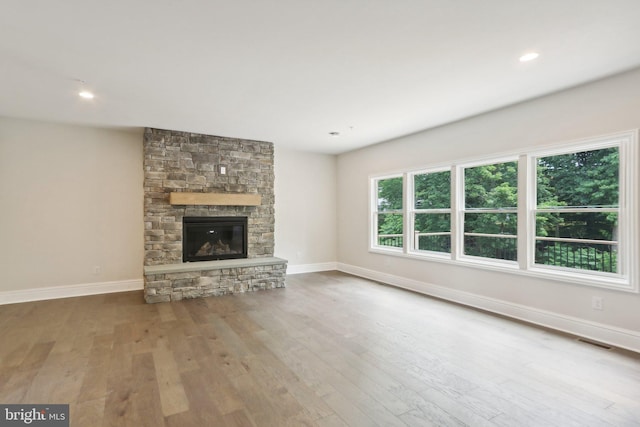 unfurnished living room featuring a fireplace and hardwood / wood-style floors