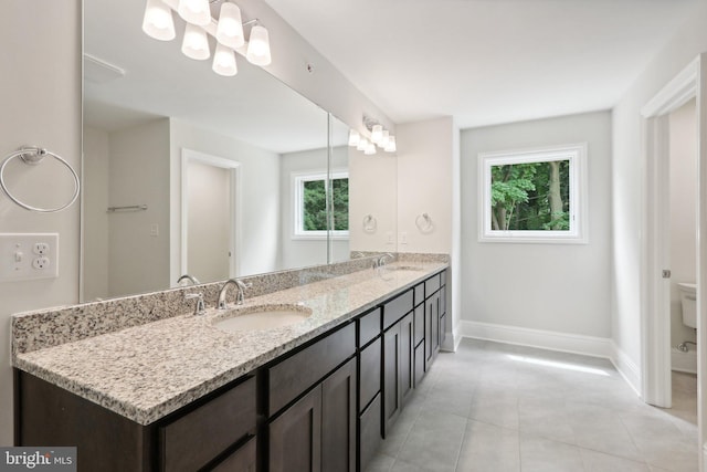 bathroom featuring tile patterned flooring, vanity, and toilet