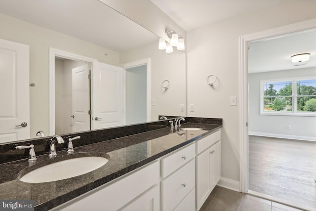 bathroom with tile patterned floors and vanity