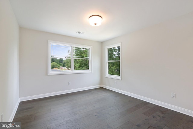 unfurnished room with dark hardwood / wood-style floors