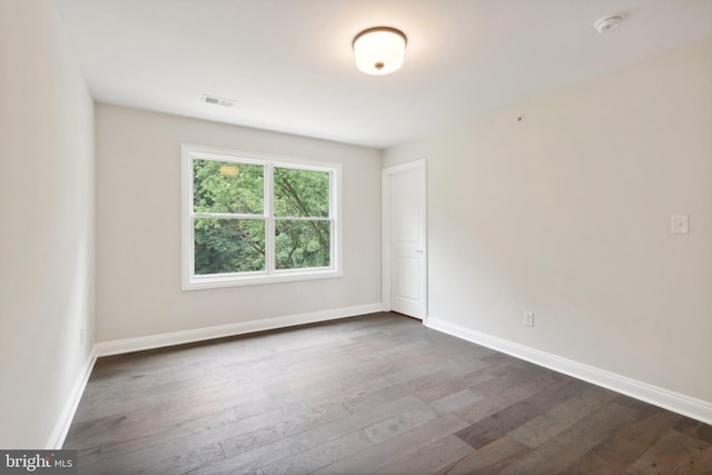 spare room with dark hardwood / wood-style flooring