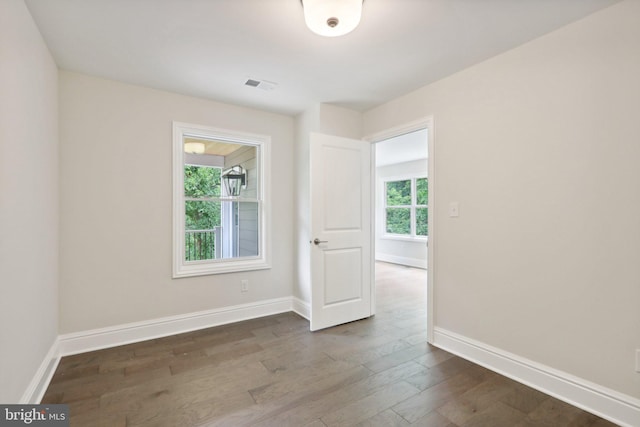 empty room featuring dark hardwood / wood-style flooring