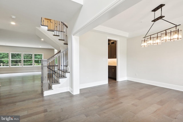 interior space with ornamental molding and hardwood / wood-style floors