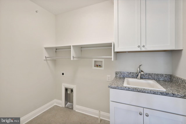 clothes washing area with electric dryer hookup, sink, hookup for a washing machine, and cabinets