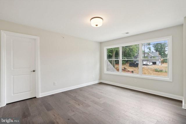 empty room featuring dark wood-type flooring