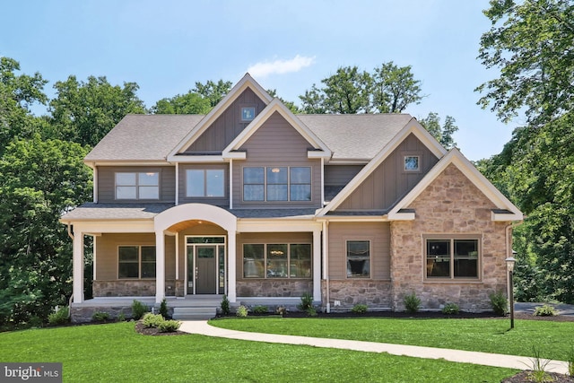 craftsman-style house with a front yard and covered porch