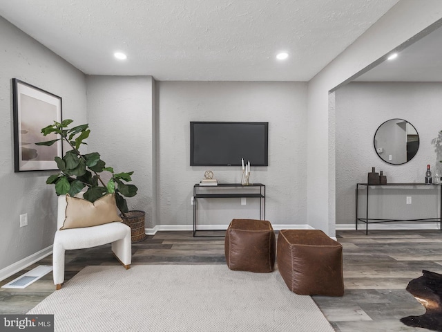 sitting room featuring hardwood / wood-style floors and a textured ceiling